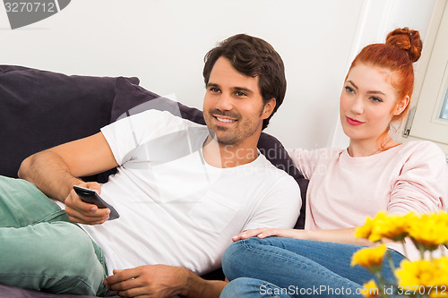 Image of Happy Couple on the Couch, Looking Into Distance