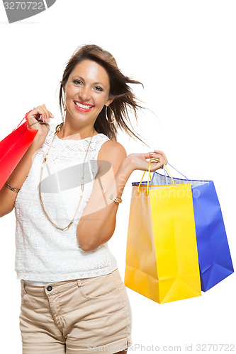 Image of Happy Woman Raising Colored Shopping Bag