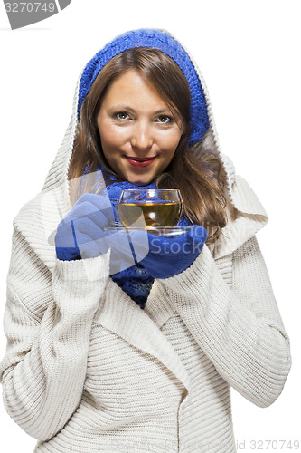 Image of Fashionable young woman sipping hot tea