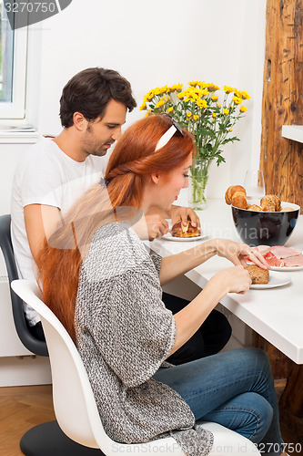 Image of Couple Preparing Ham Sandwich at the Table