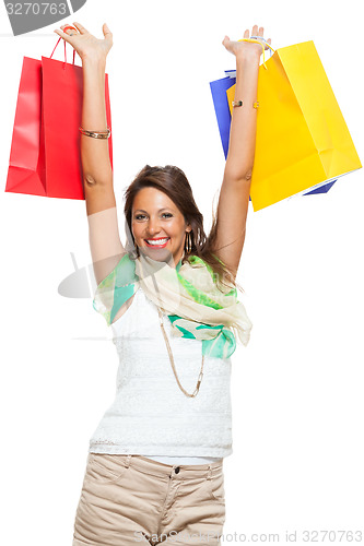 Image of Happy Woman Raising Colored Shopping Bag