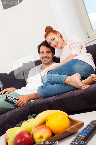 Image of Happy Couple on the Couch, Looking Into Distance