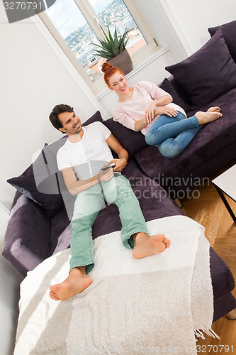 Image of Happy Couple on the Couch, Looking Into Distance