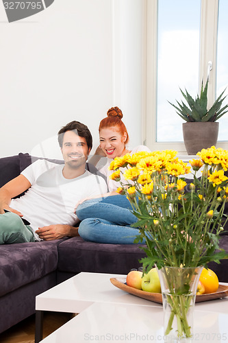 Image of Happy Couple on the Couch, Looking Into Distance