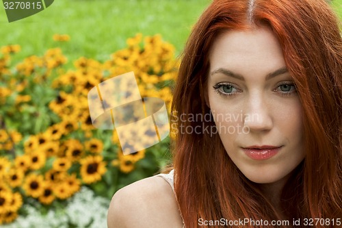 Image of Long Hair Woman At the Garden looking Afar