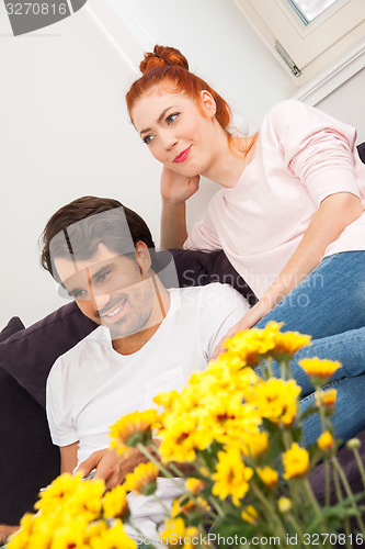 Image of Happy Couple on the Couch, Looking Into Distance