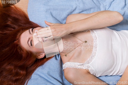 Image of Very Happy Woman Lying on Bed 