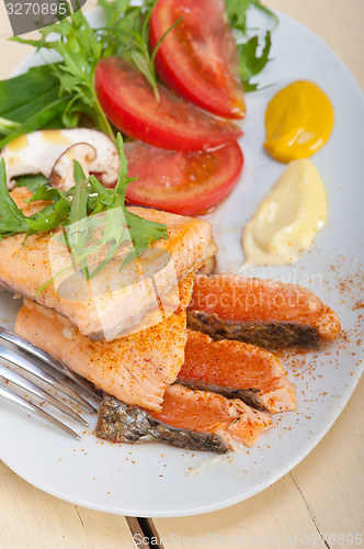 Image of grilled samon filet with vegetables salad