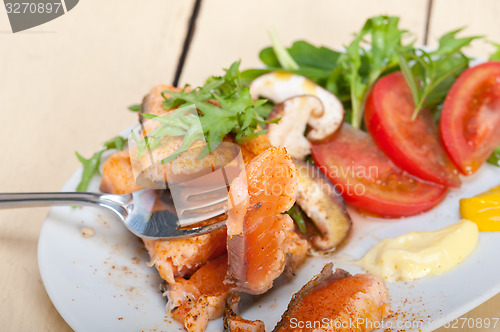 Image of grilled samon filet with vegetables salad