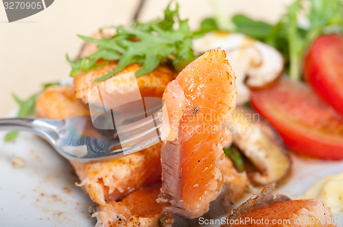 Image of grilled samon filet with vegetables salad