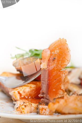 Image of grilled samon filet with vegetables salad