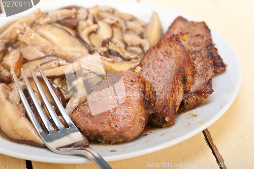 Image of venison deer game filet and wild mushrooms