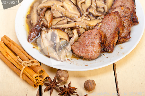 Image of venison deer game filet and wild mushrooms