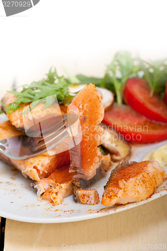 Image of grilled samon filet with vegetables salad