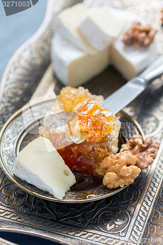 Image of Honey comb, cheese and walnuts.