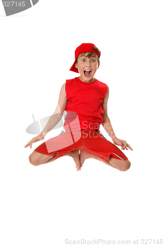 Image of Excited boy jumping off the ground.