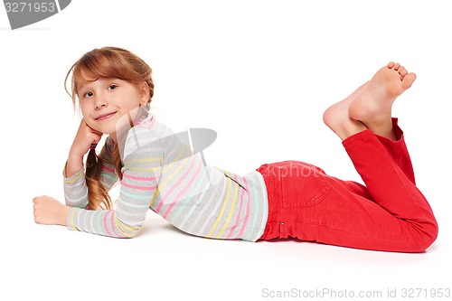 Image of Side view of smiling child girl lying on stomach