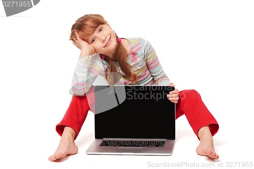 Image of Little girl sitting on floor showing laptop screen