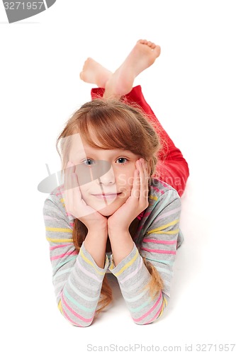 Image of Front view of smiling child girl lying on stomach
