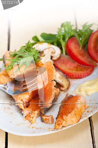 Image of grilled samon filet with vegetables salad