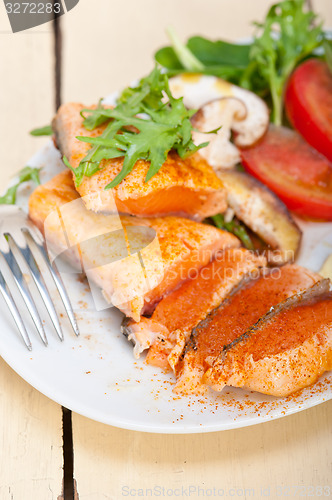 Image of grilled samon filet with vegetables salad