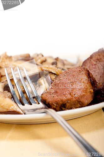 Image of venison deer game filet and wild mushrooms