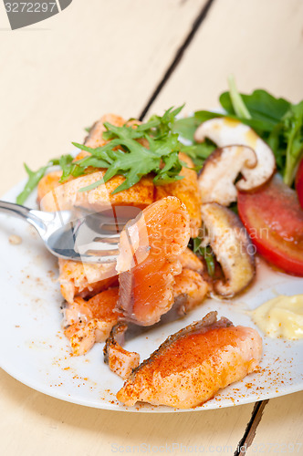 Image of grilled samon filet with vegetables salad