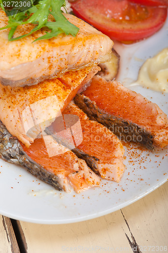 Image of grilled samon filet with vegetables salad