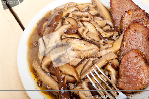 Image of venison deer game filet and wild mushrooms