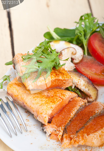 Image of grilled samon filet with vegetables salad