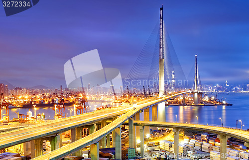 Image of Container Cargo freight ship with working crane bridge in shipya