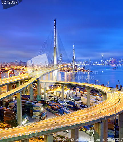 Image of Container Cargo freight ship with working crane bridge in shipya