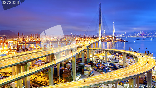 Image of Container Cargo freight ship with working crane bridge in shipya