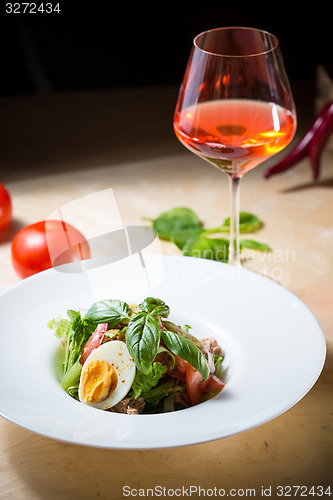 Image of plate of spring mix salad with strawberry, eggs and tuna