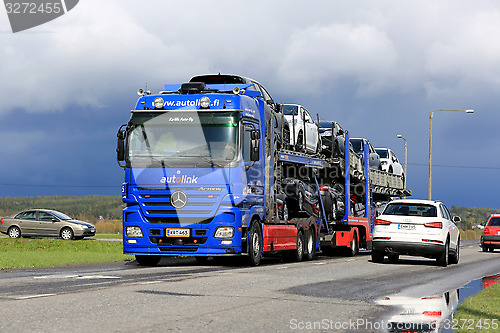 Image of Mercedes-Benz Actros Car Carrier Hauls New Cars in Traffic