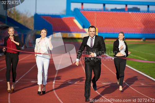 Image of business people running on racing track