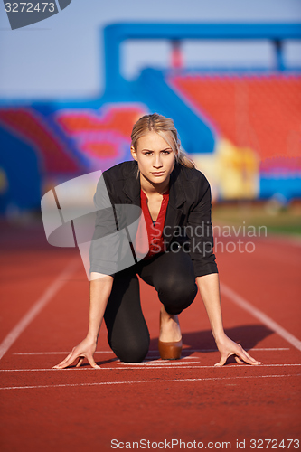 Image of business woman ready to sprint