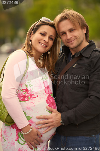 Image of young pregnant couple have fun and relax