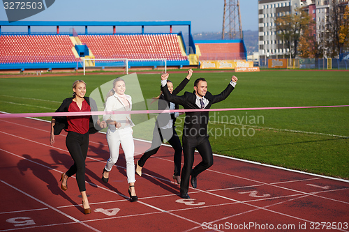 Image of business people running on racing track