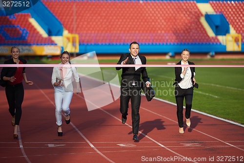 Image of business people running on racing track