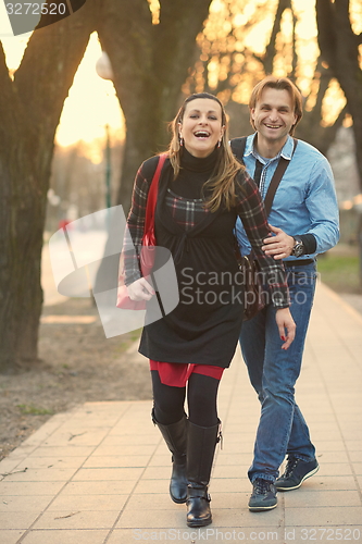 Image of young pregnant couple have fun and relax
