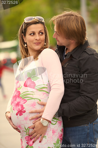Image of young pregnant couple have fun and relax