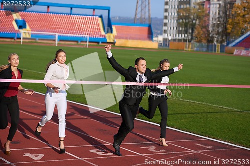 Image of business people running on racing track