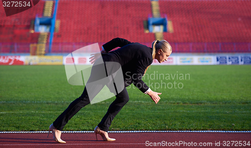 Image of business woman ready to sprint