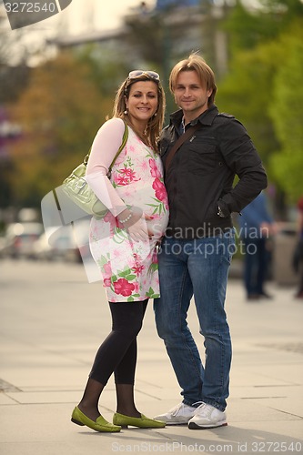Image of young pregnant couple have fun and relax