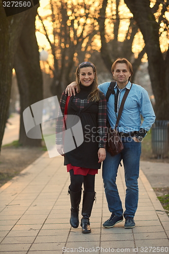 Image of young pregnant couple have fun and relax