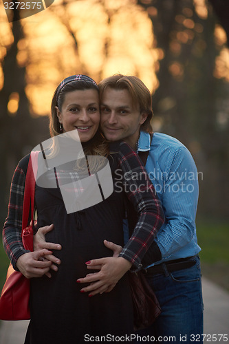 Image of young pregnant couple have fun and relax
