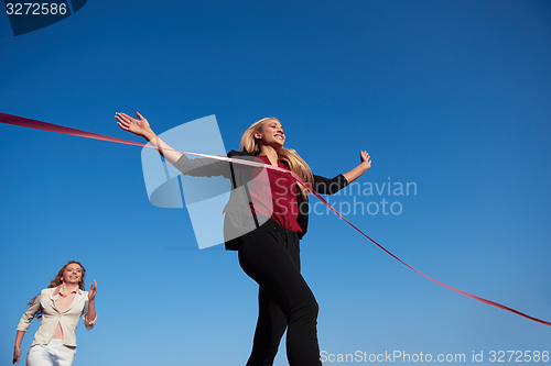 Image of business people running on racing track