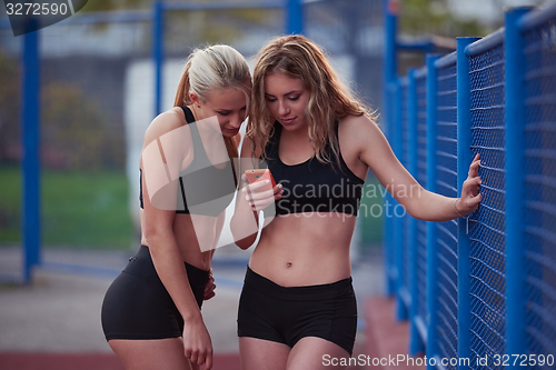 Image of sporty woman on athletic race track