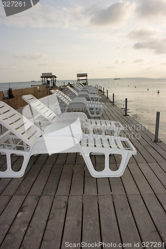 Image of Chaise longues on pier